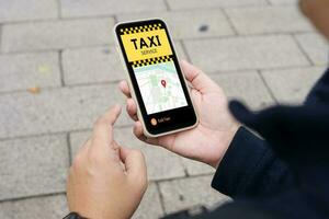 Man in downtown city street ordering taxi using smart phone app Booking taxi using application online on smart phone photo