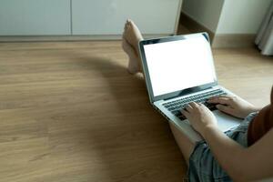 Woman Working by using laptop blank screen computer . Hands typing on a keyboard.technology e-commerce concept. photo