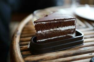 Homemade chocolate cake Slice of homemade chocolate cake on wooden photo
