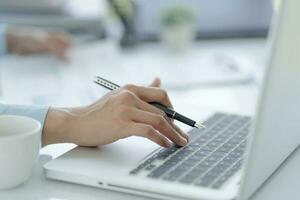 Business man working using laptop computer Hands typing keyboard. Professional investor working start up project. business planning in office. Technology business Concept photo