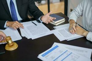 abogado legal consejo regalos a el cliente un firmado contrato con mazo y legal ley. justicia y abogado negocio camaradería reunión concepto. foto