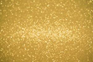 Gold glitters background. shimmering blur spot lights Bokeh Shiny gold light background. photo