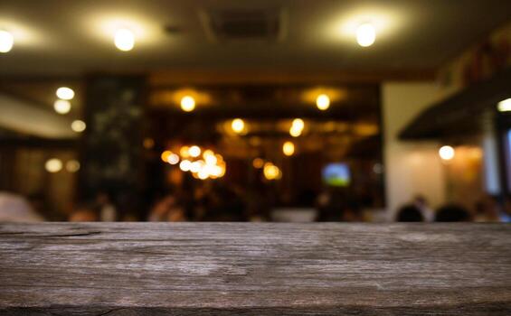 Empty wooden table in front of abstract blurred background of coffee shop . can be used for display Mock up  of product photo