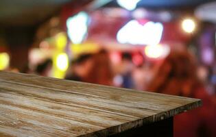 Empty wooden table in front of abstract blurred background of coffee shop . can be used for display or montage your products.Mock up for display of product photo