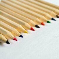 Kid Art education concept. Color pencils on white paper background. copy space photo