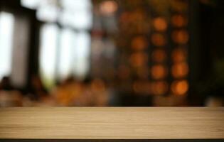 Empty wooden table in front of abstract blurred background of coffee shop . can be used for display or montage your products.Mock up for display of product photo