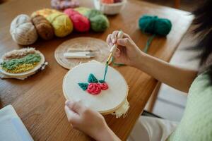 Punch needle. Asian Woman making handmade Hobby knitting in studio workshop. designer workplace Handmade craft project DIY embroidery concept. photo