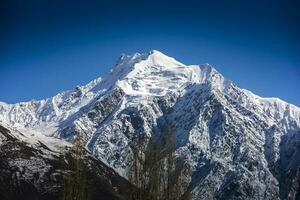 Beautiful snow mountain with Blue Sky from pakistan. photo