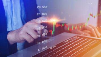Businessman finger touch symbol stock graph and chart background, concept growth and development business investment, Stock market and strategy making market plan and stock market fluctuations photo
