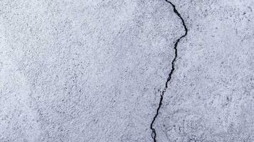 Grungy wall with large cracked cement floor texture, Cement large crack for background photo