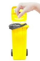 hand women Pick catch , yellow Garbage bins isolated on white photo