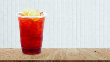 Iced tea and lemon slices on wooden table on white background, Summer drinks with ice photo