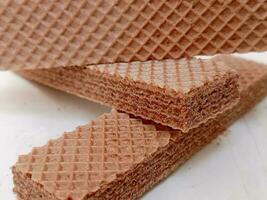 Delicious chocolate wafers on white background photo