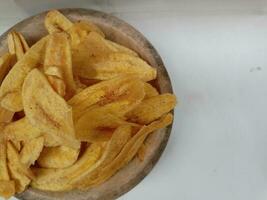 Banana chips isolated on white background photo