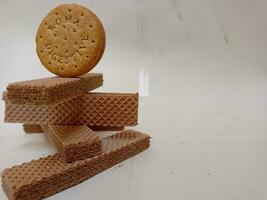 Delicious chocolate wafers on white background photo