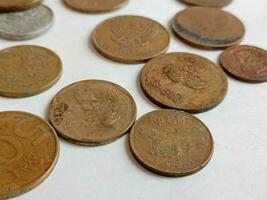 many ancient coins isolated from Indonesia. Rupiah currency photo