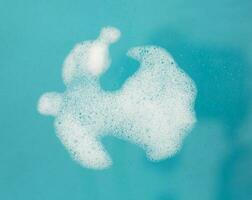 White foam bubble isolated on blue photo