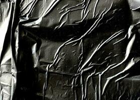 Abstract black glued plastic texture background photo