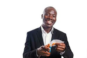 a smiling black professional formal wearing man using scissor to cut paper photo