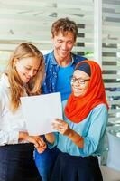 Multiracial team working together on documents photo