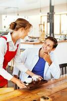 waitress serving tea for a client in restaurant photo