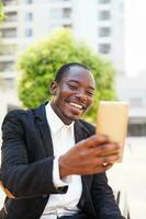 african man using a front camera of the phone photo