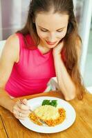 woman eating traditional indonesian morning food - nasi kuning photo