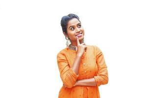 Pretty Indian woman in kurta thinking and looking up over white background photo