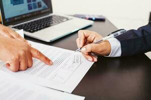 Faceless photo of a woman signing approved loan application