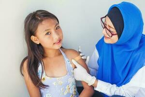 muslim doctor and little girl as a patient photo