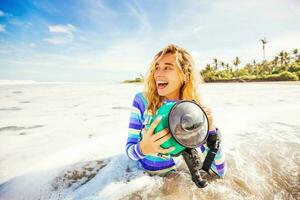 woman using underwater camera in waves photo