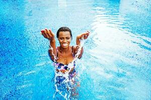 Beautiful Afro woman by the pool photo