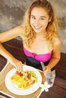 cute woman having her breakfast at a hotel photo