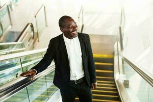 african man on an escalator photo