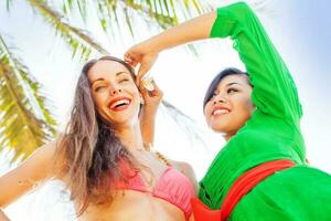 tourist woman in bali receiving a flower from a local balinese girl photo