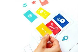 Hand putting blocks on phone. Web development concept photo