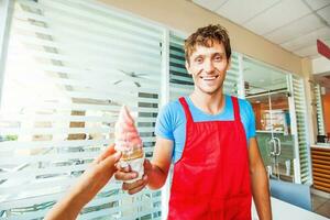 ice cream seller giving ice cream to a customer photo