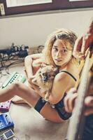 beautiful sexy girl watching her boyfriend playing guitar photo