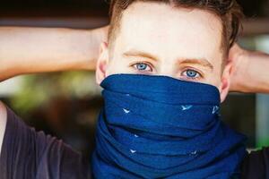 guy with his face half covered with scarf photo