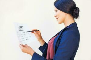 Woman checking office tasks as completed in to-do list photo