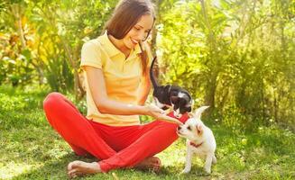 woman playing with her can and dog outdoors photo