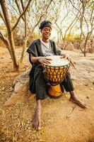 african drummer playing photo