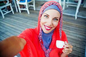 muslim caucasian woman taking selfie photo