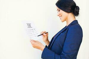 Woman checking office tasks as completed in to-do list photo