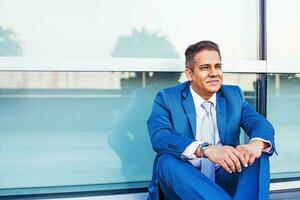 mixed race man wearing a blue suit smiling photo