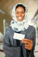 beautiful young african woman holding a blank visiting card photo