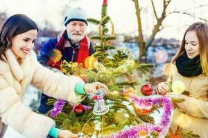 Family setting up a Christmas tree photo