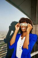 Beautiful African woman wearing 3d goggles photo