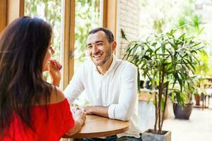 man looking at the woman on a date in cafe photo