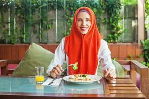 Muslim woman enjoying halal food and juice photo
